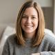 Portrait of Sarah M., a satisfied homeowner customer, friendly smile, natural background