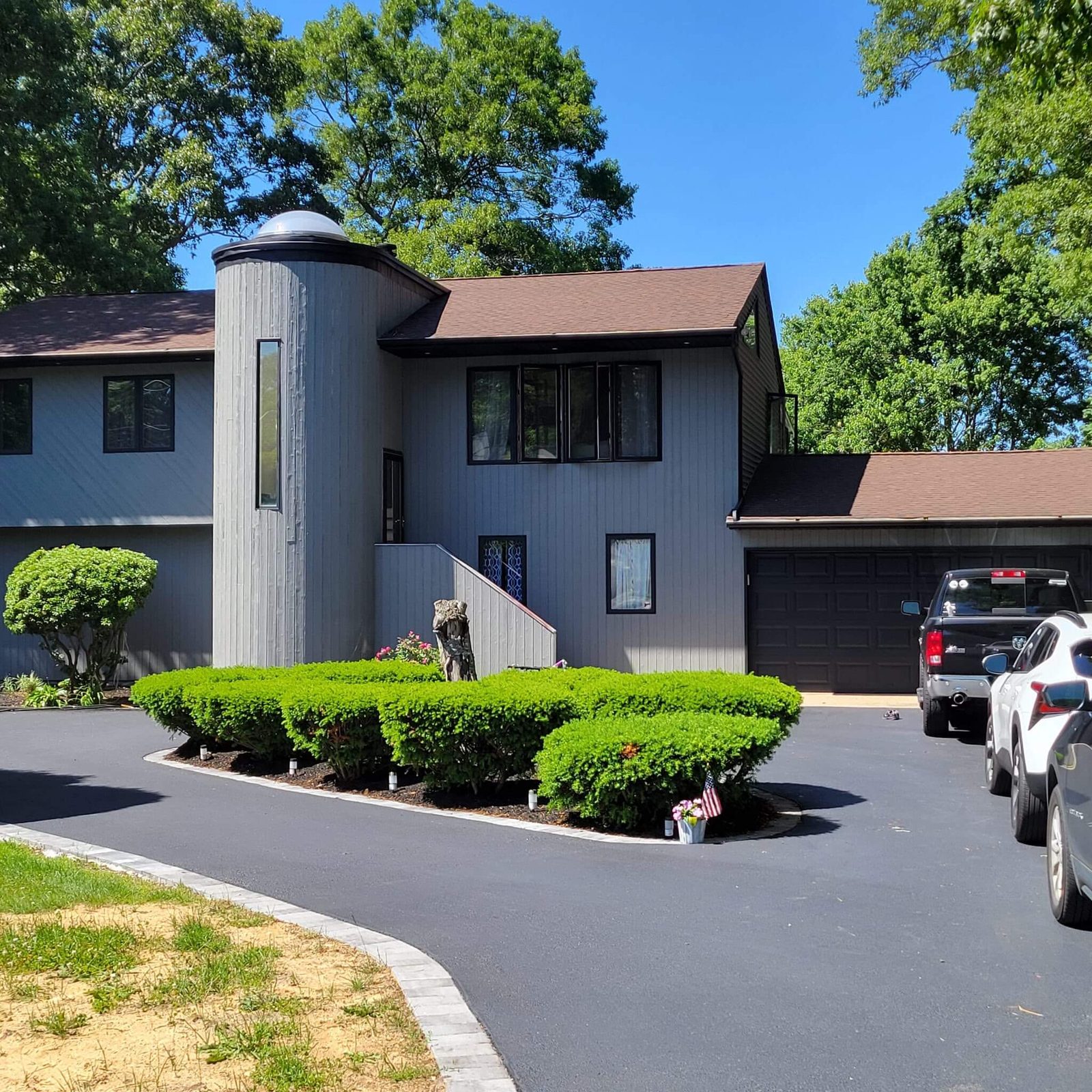 After: the same home freshly repainted in a clean modern gray with crisp trim