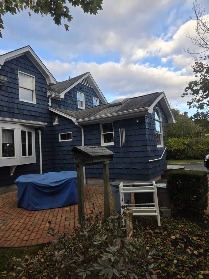 Navy blue shingle-style home exterior with white trim