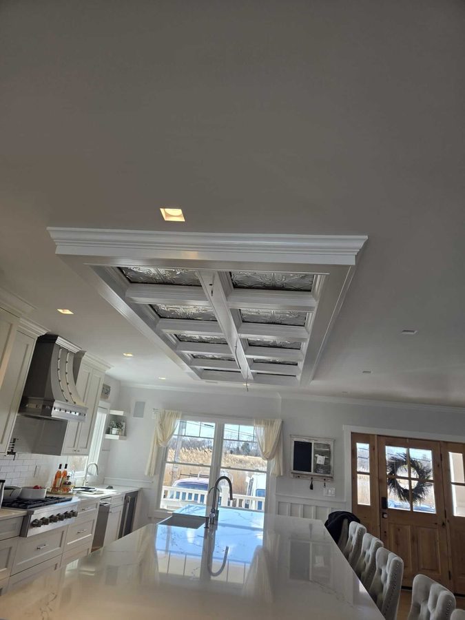 Freshly painted dining room with detailed coffered ceiling millwork