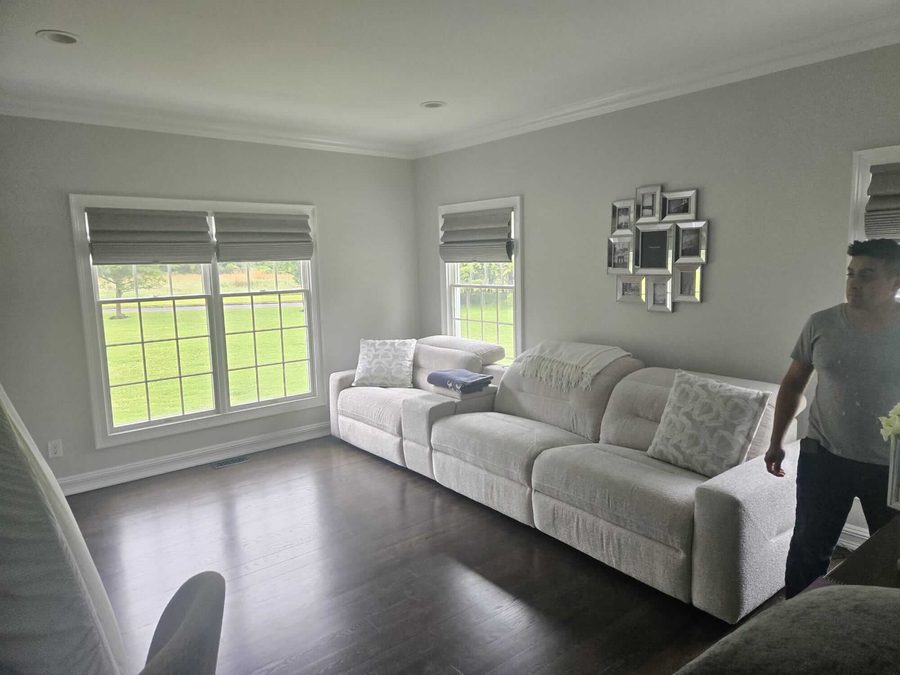 Freshly painted living room in soft gray with white crown molding
