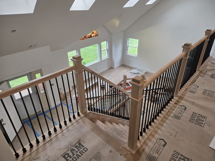 Freshly painted upstairs landing and staircase with black baluster railings